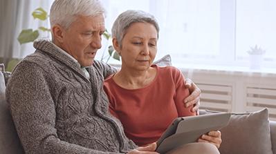 Couple reviewing their Medicare plan on a tablet.
