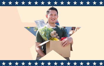 Person holding a box of donated groceries inside a star shape, framed by a patriotic border, representing a Memorial Day food donation drive.